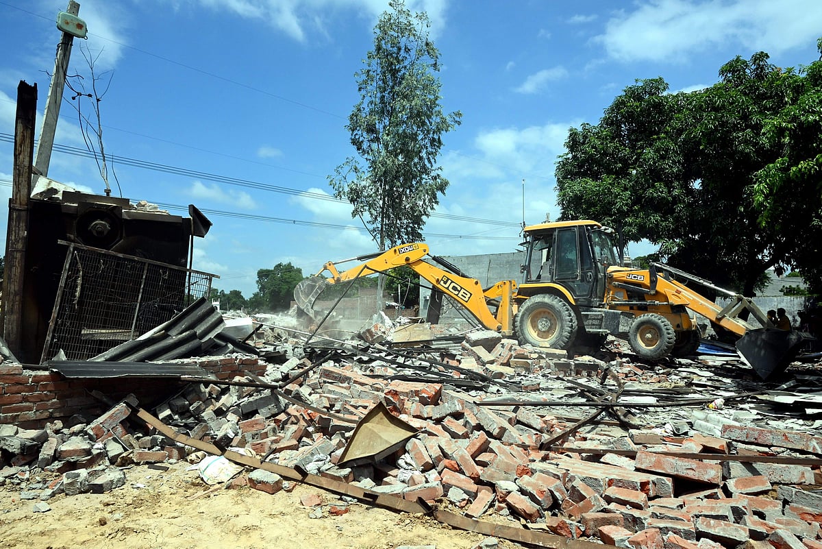 PTI : A bulldozer being used to demolish the bakery of Moid Khan who is accused of allegedly raping a 12-year-old girl, in Ayodhya, Saturday